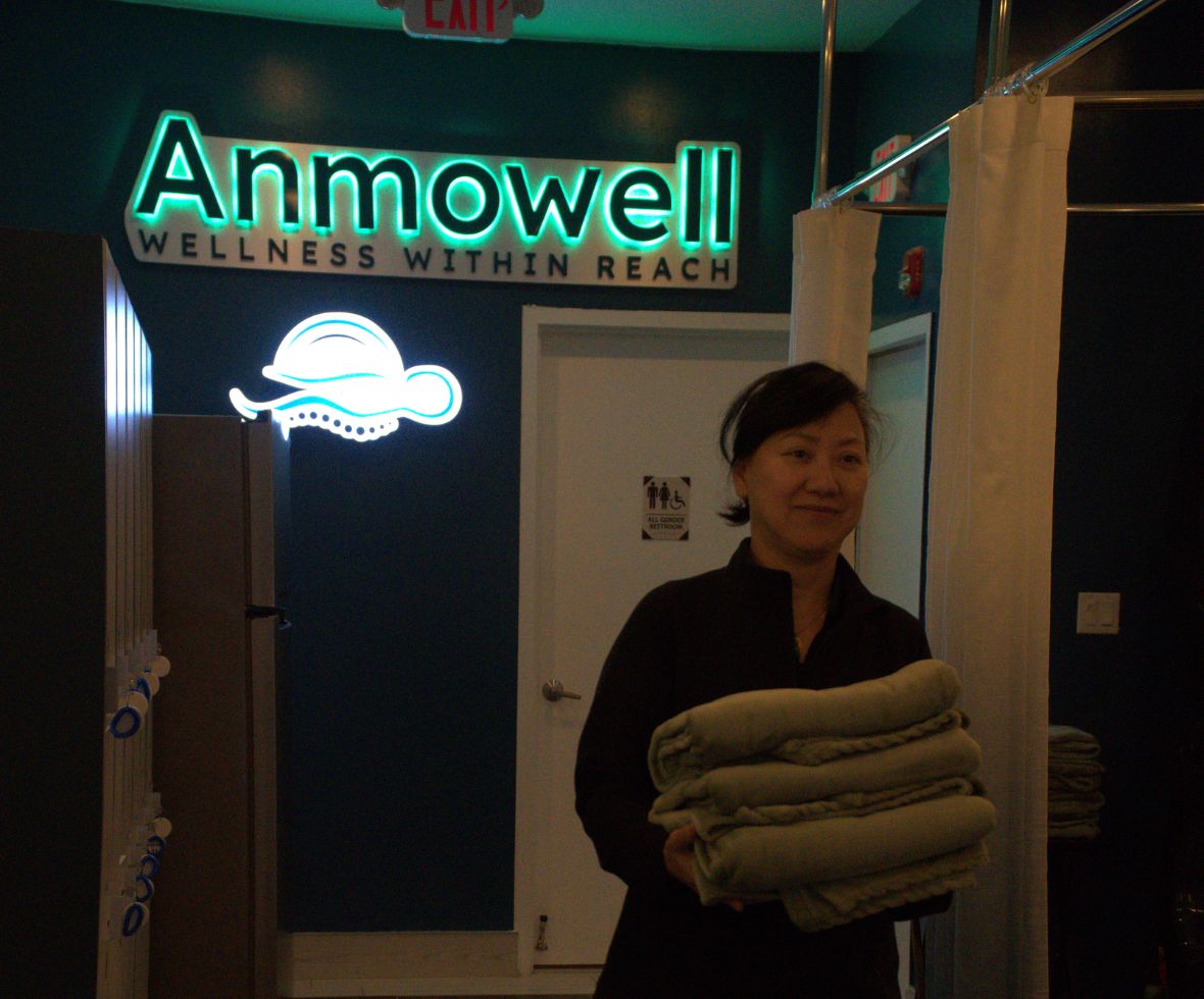 anmowell interior with worker holding warm towels