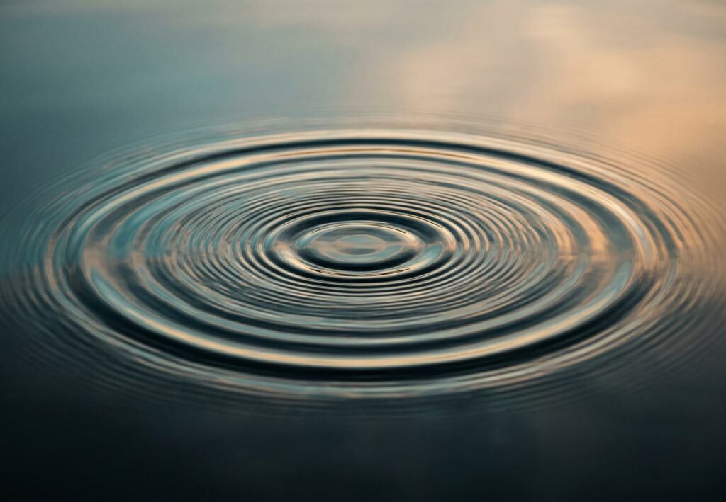 Concentric ripples spreading across calm water, illustrating how vibration therapy travels through the body for back pain relief