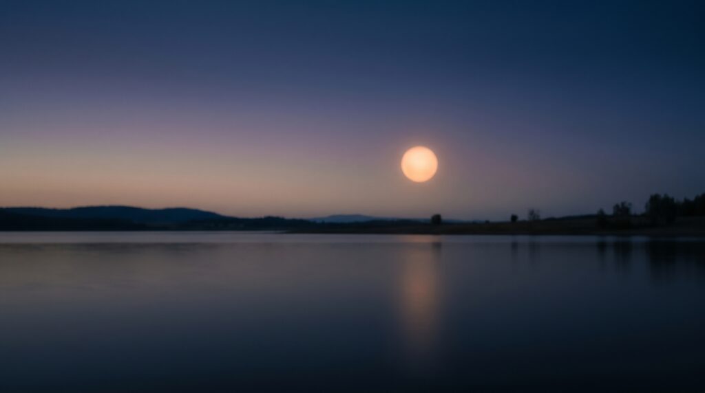 Soft warm glow over calm dusk tones evoking restful sleep — tranquil wellness imagery