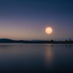 Soft warm glow over calm dusk tones evoking restful sleep — tranquil wellness imagery