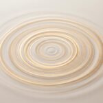Abstract concentric vibration waves in warm tones representing sonic wellness therapy